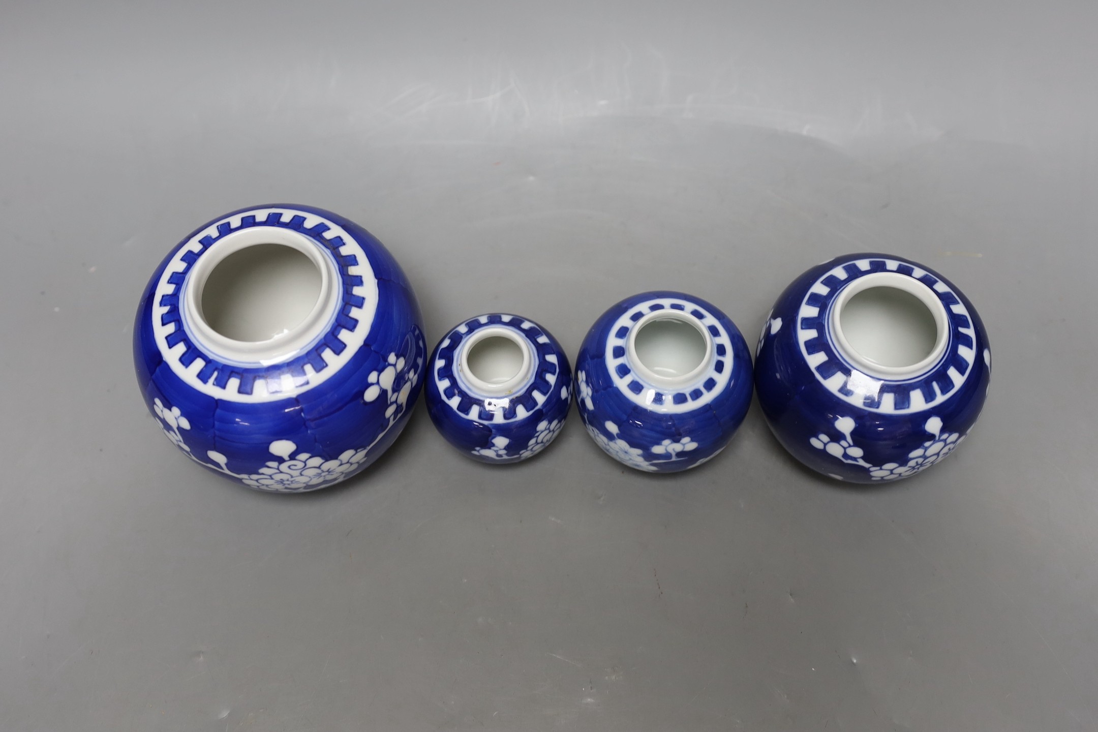 A Chinese bronze hand warmer and four Chinese blue and white Prunus jars and covers. Tallest 12cm